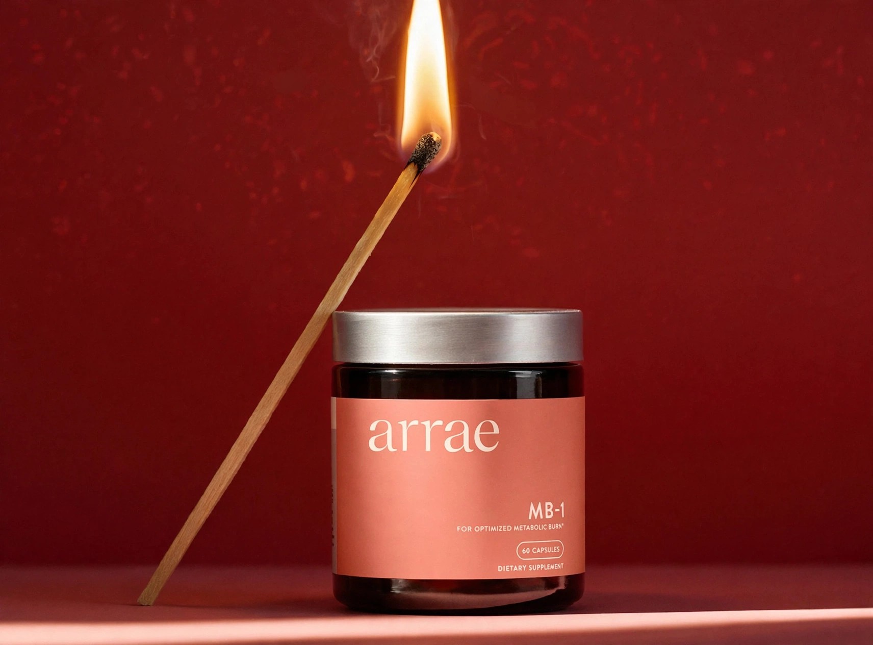 A jar of Arrae MB-1 styled with a burning match.