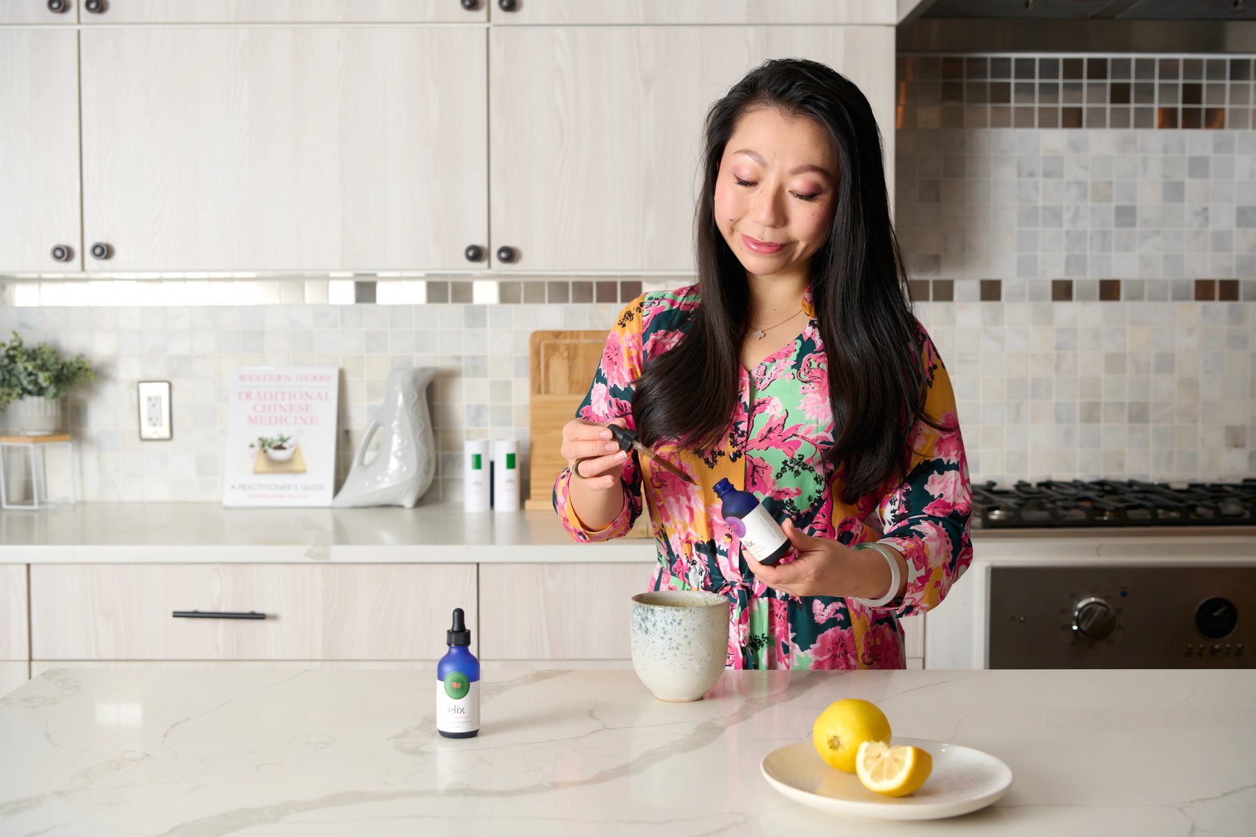 Founder Lulu Ge prepares an Elix drink at the kitchen counter.