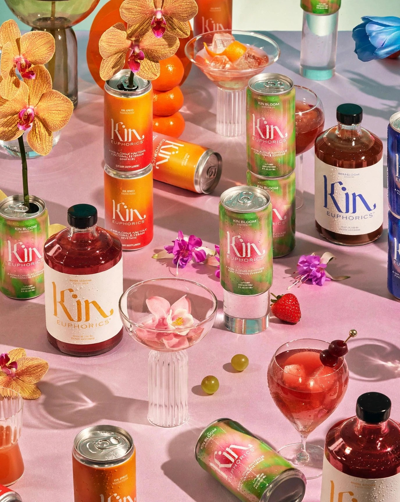 Colorful Kin drinks arranged with fruit flowers and glasses.