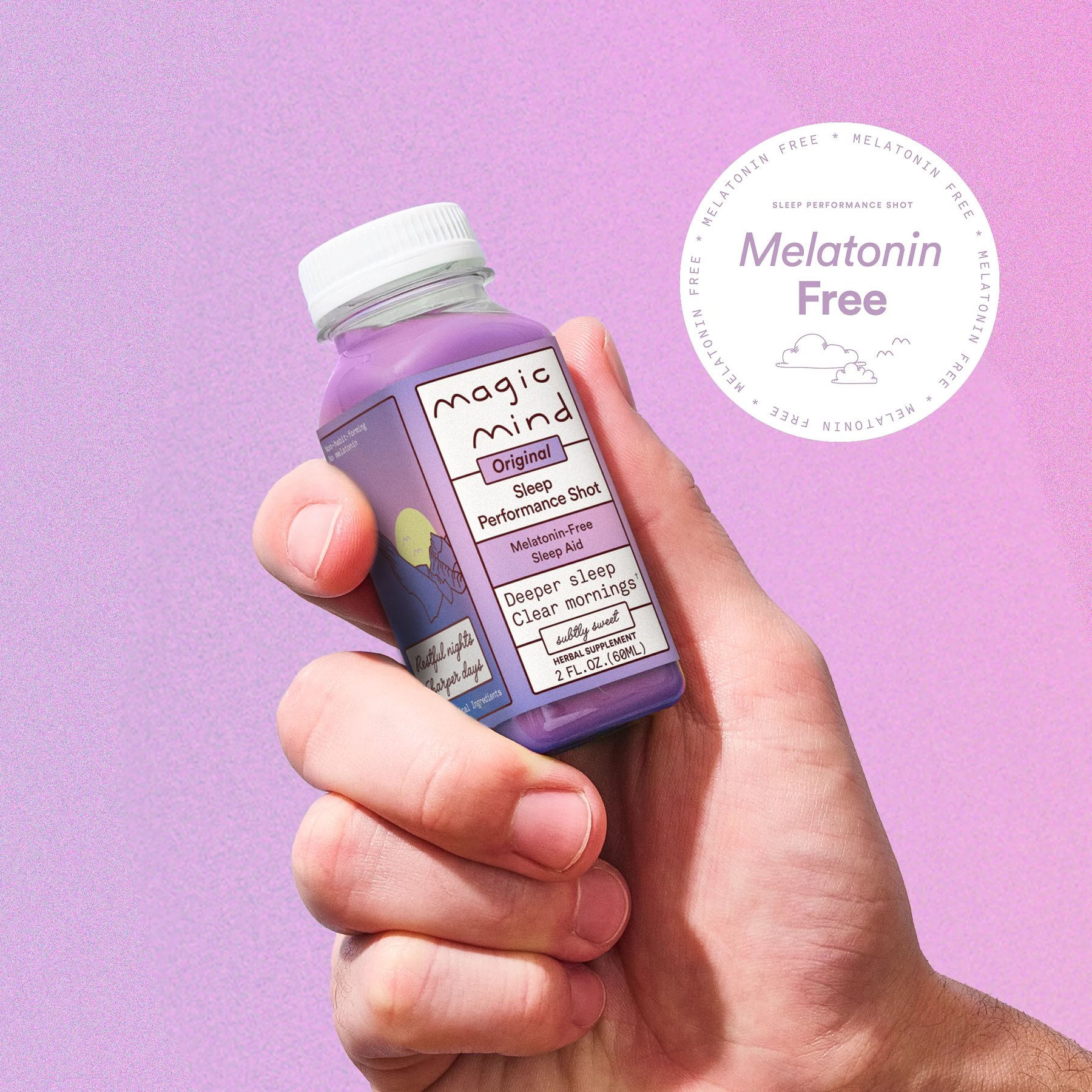 Fingers gripping a small Magic Mind Sleep shot bottle.