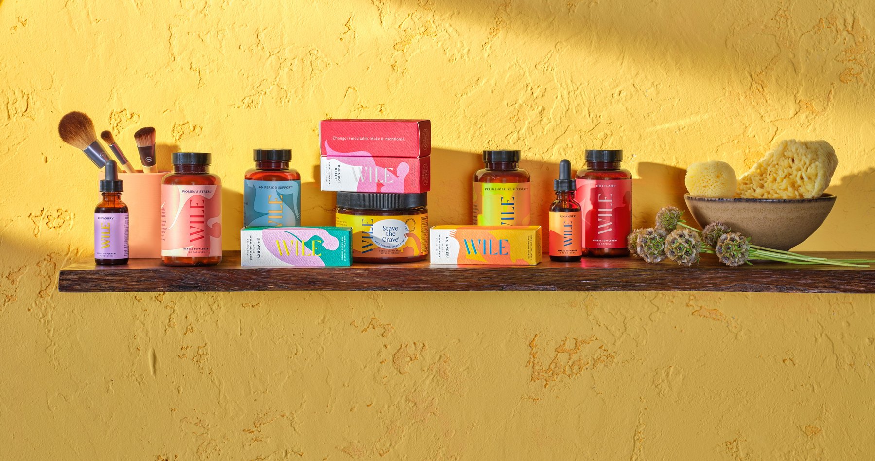 Wile product lineup displayed on shelf before yellow wall.
